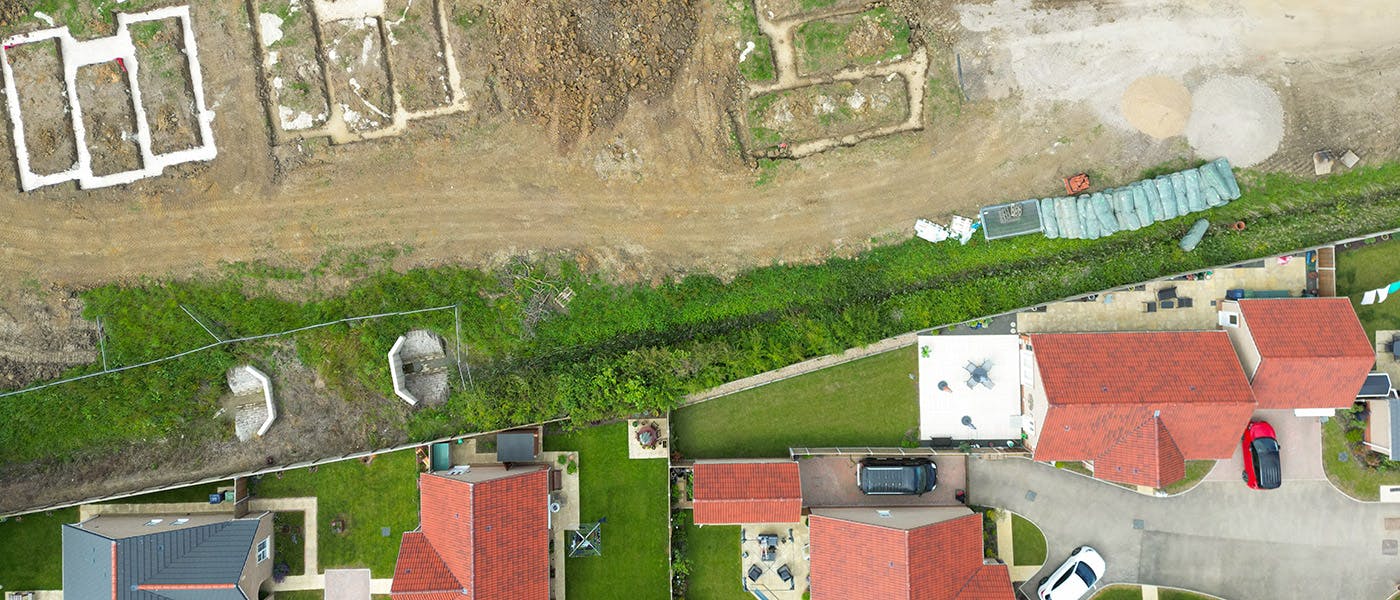 Aerial shot of a housing development, showing new-build houses and new plots being readied for development