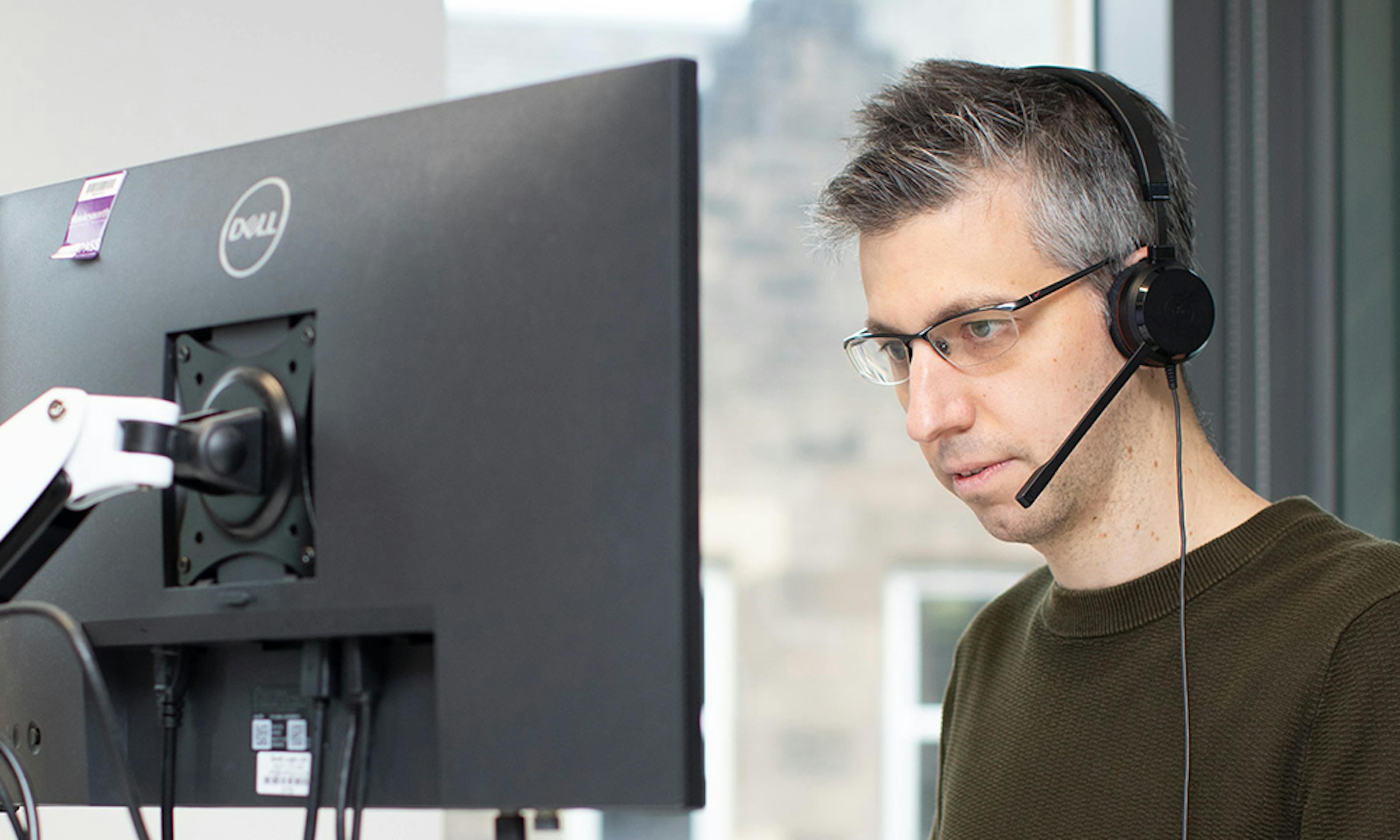 Man coding using two screens