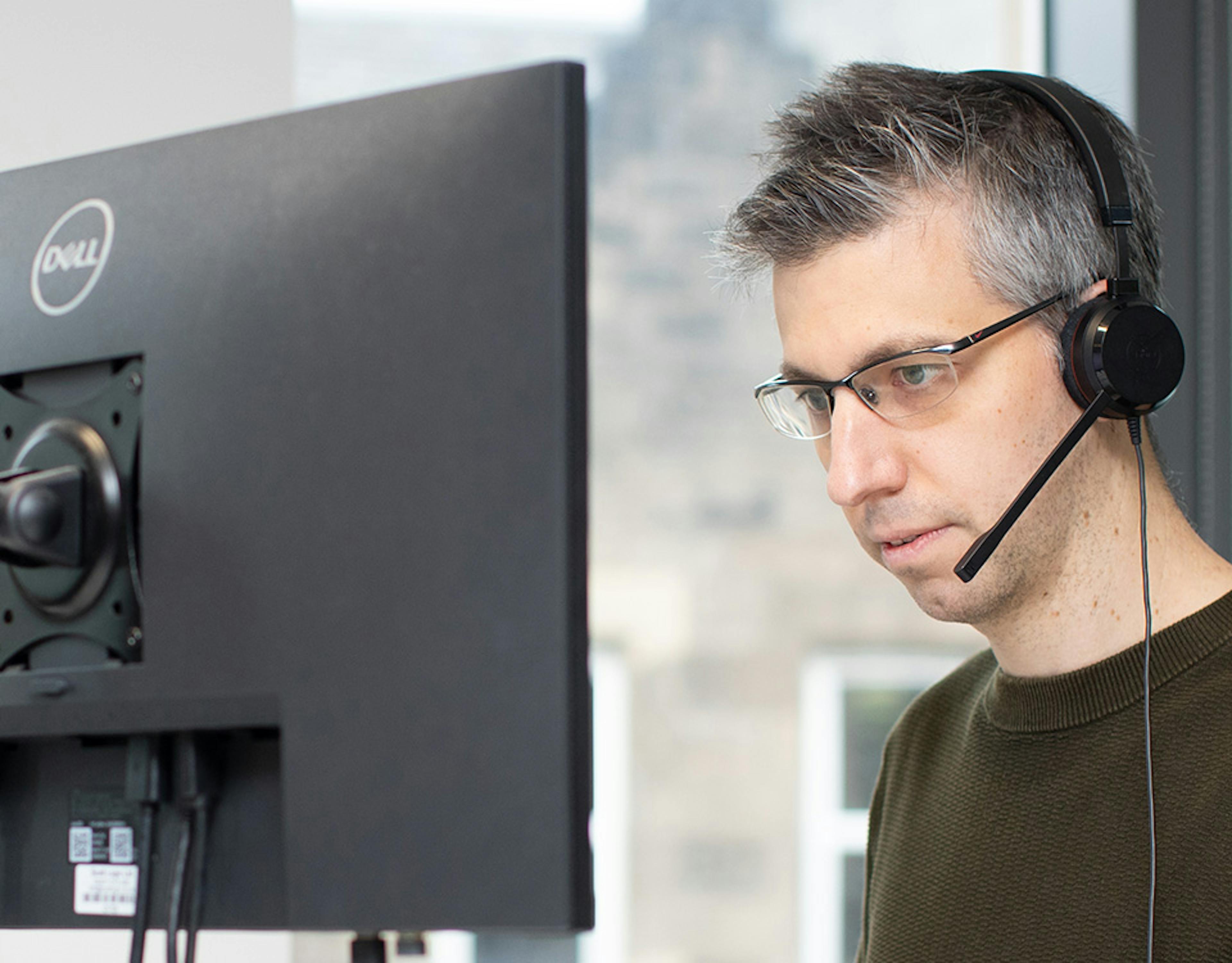 Man coding using two screens