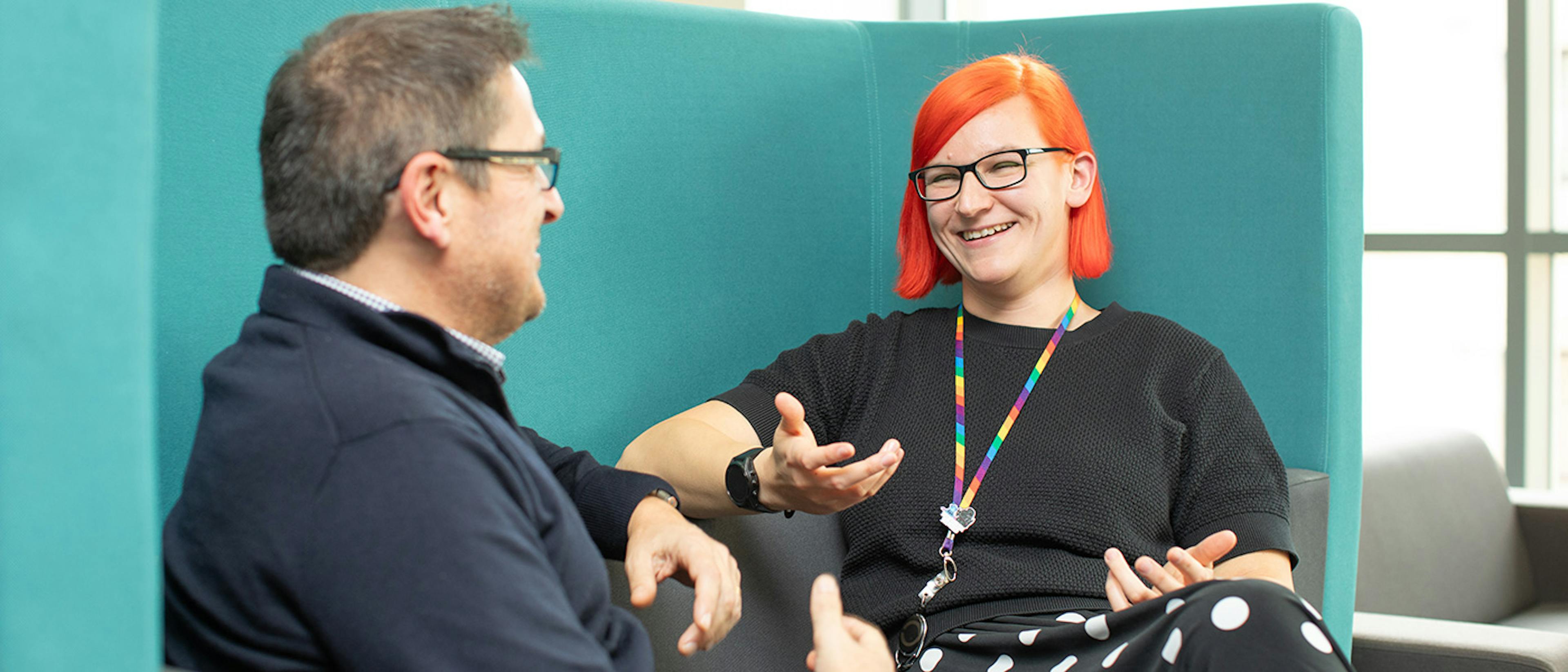 Two people in an informal meeting in an office setting