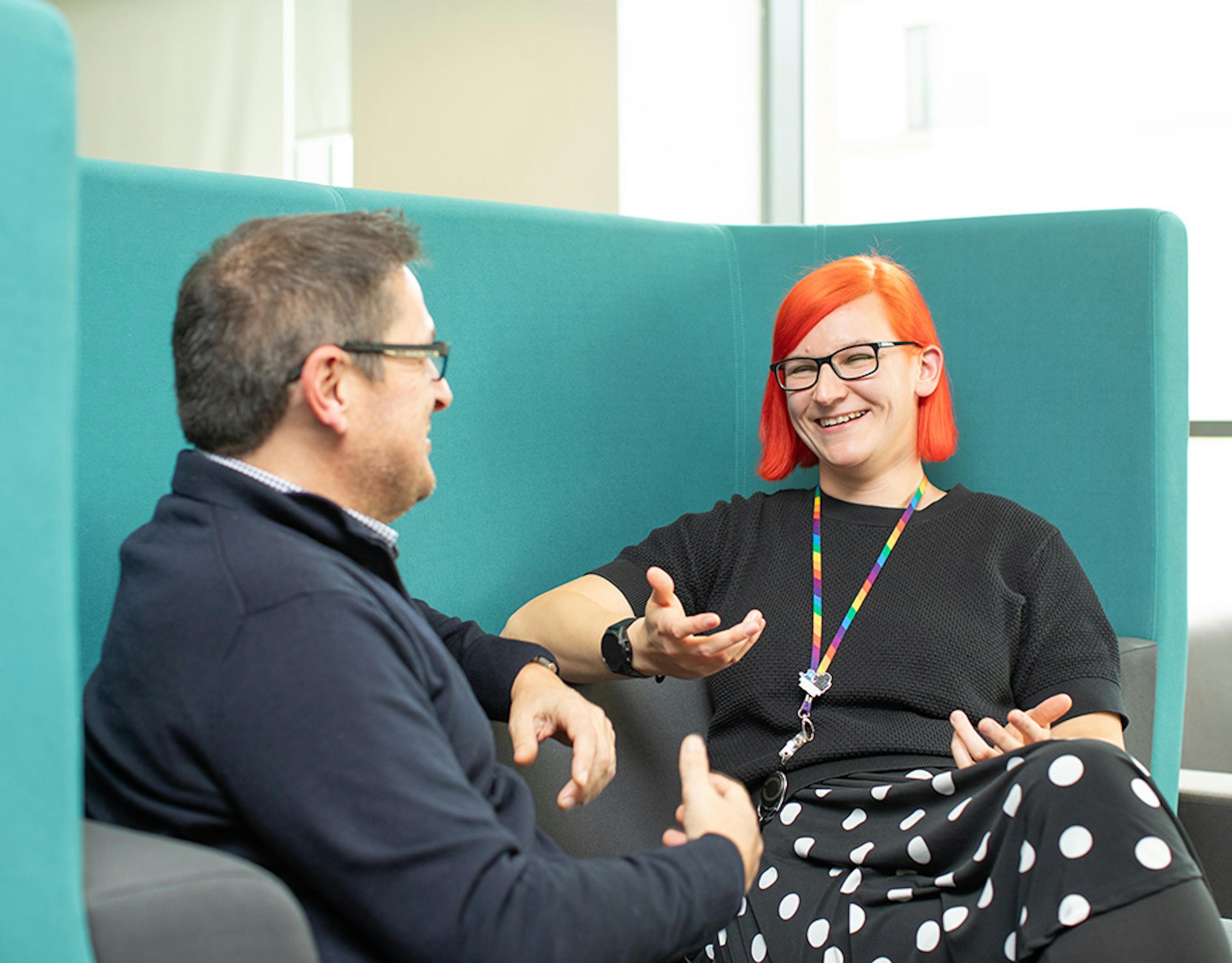 Two people in an informal meeting in an office setting