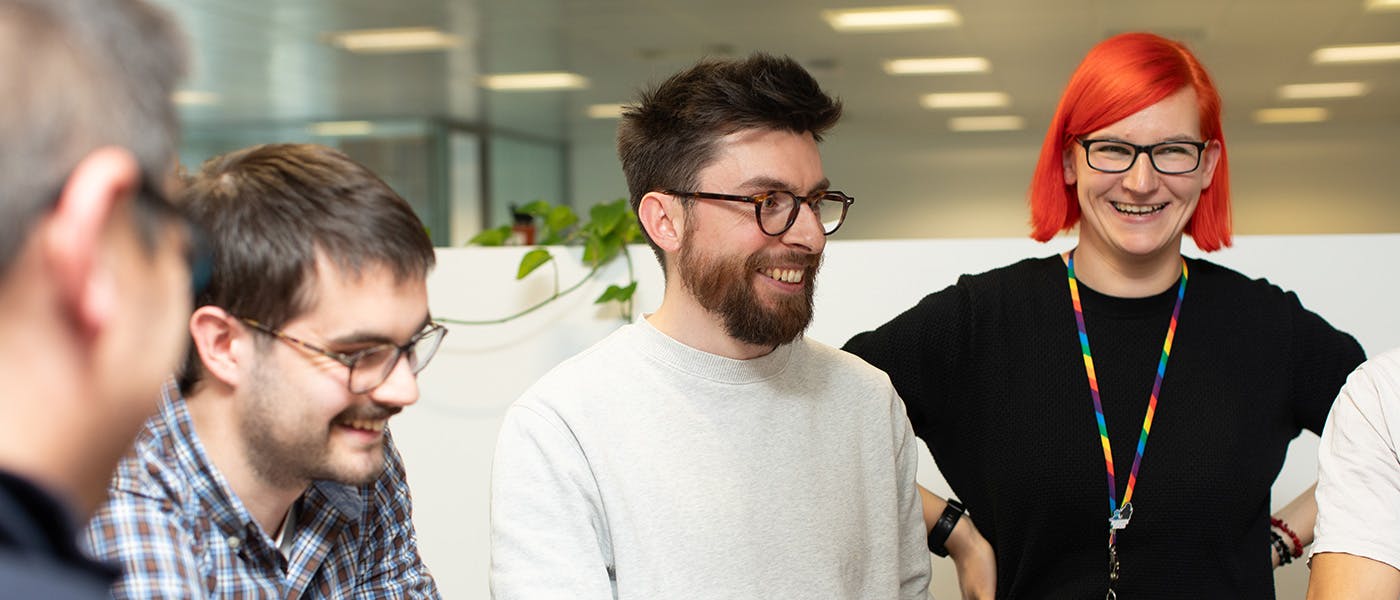 People in an office in a stand-up meeting