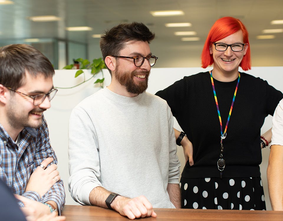 People in an office in a stand-up meeting