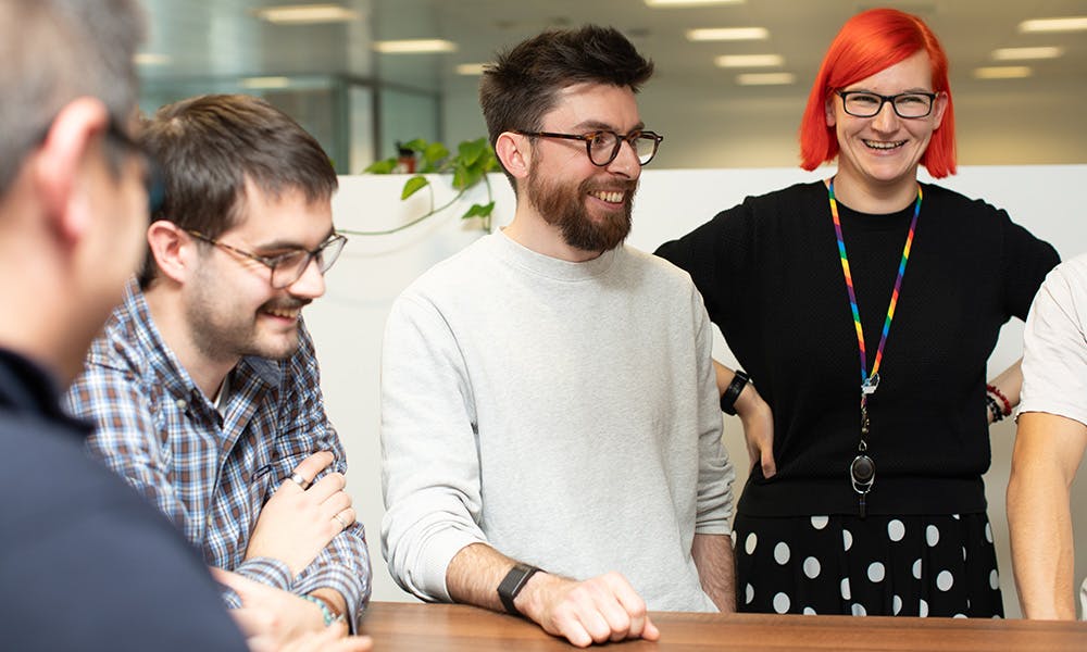 People in an office in a stand-up meeting