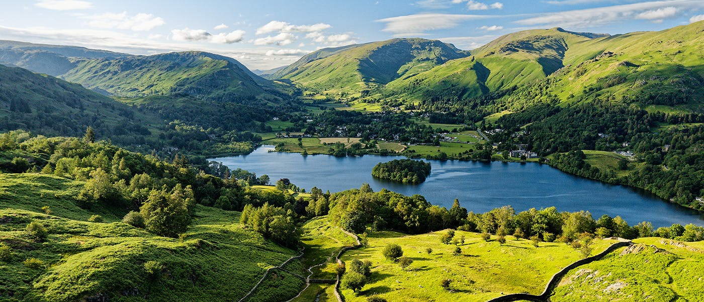 An aerial view of a lake surrounded by hills