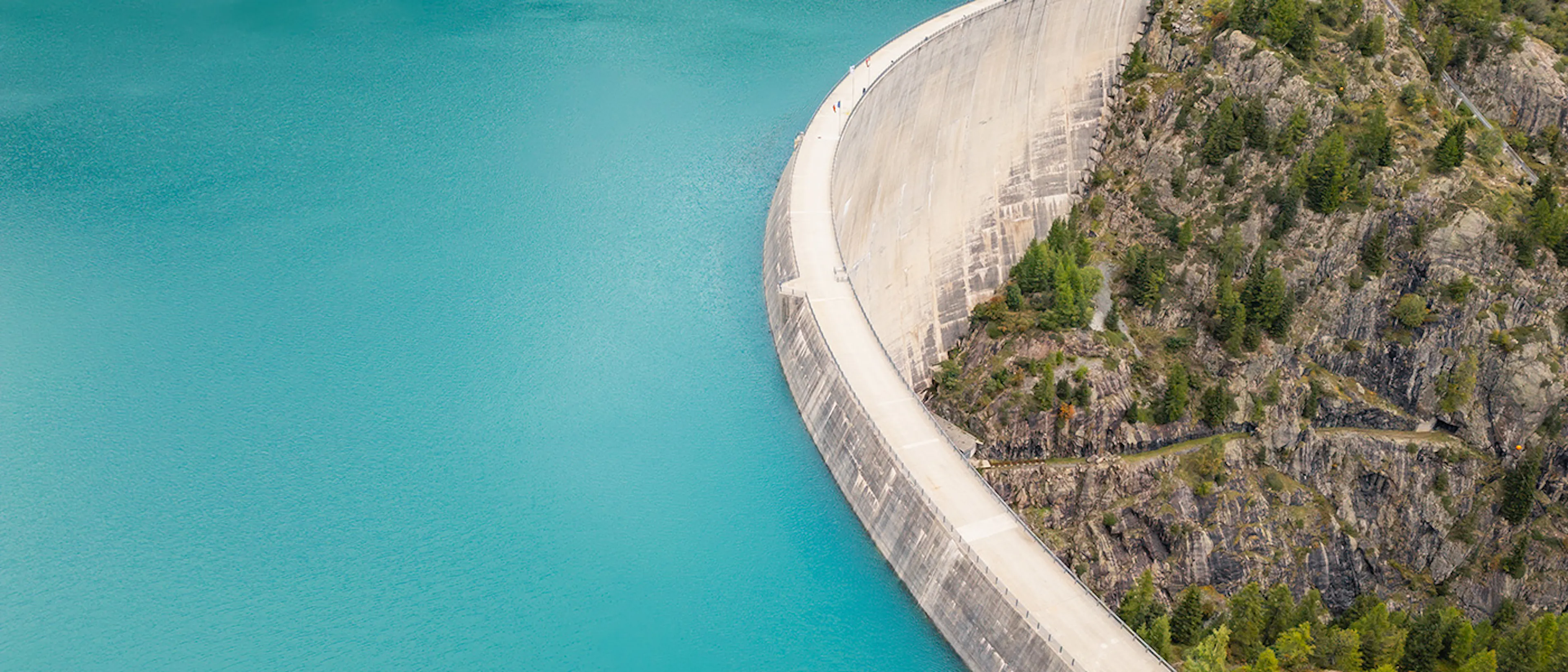 Aerial panoramic view of a dam and reservoir in the Swiss Alps
