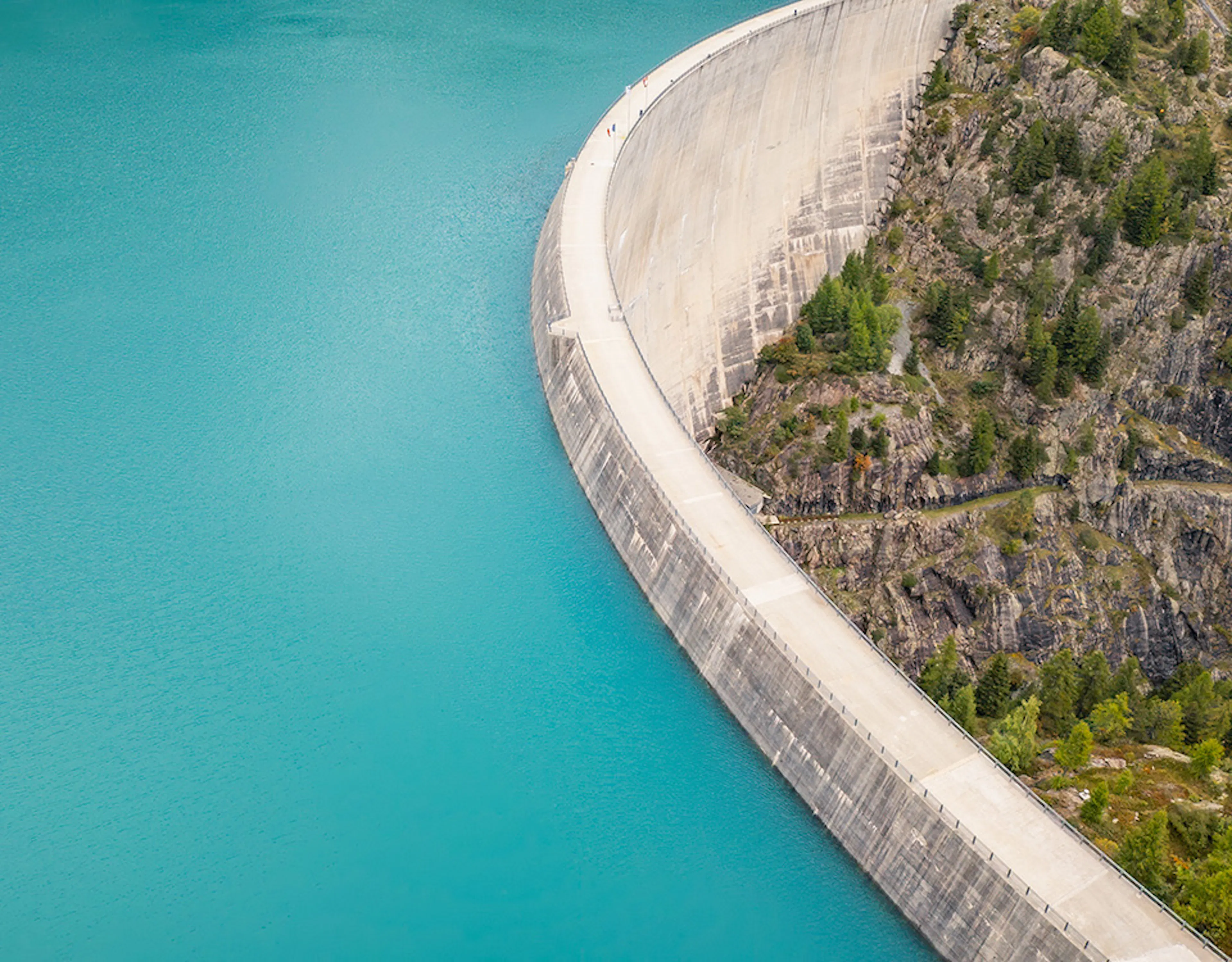 Aerial panoramic view of a dam and reservoir in the Swiss Alps