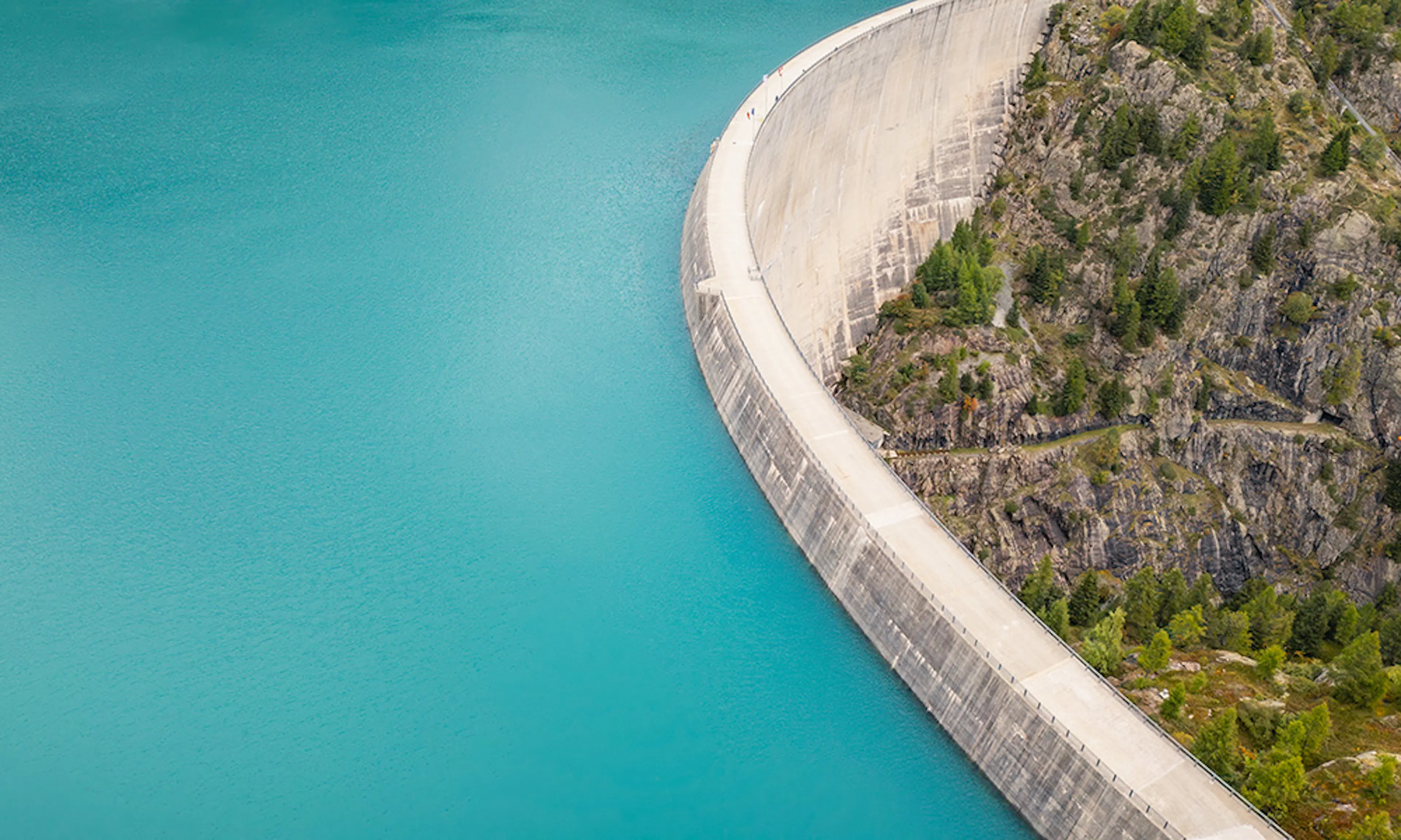 Aerial panoramic view of a dam and reservoir in the Swiss Alps