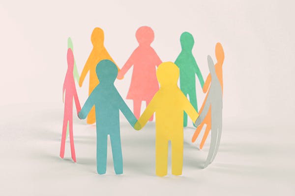 Cut-out paper figures standing in a circle