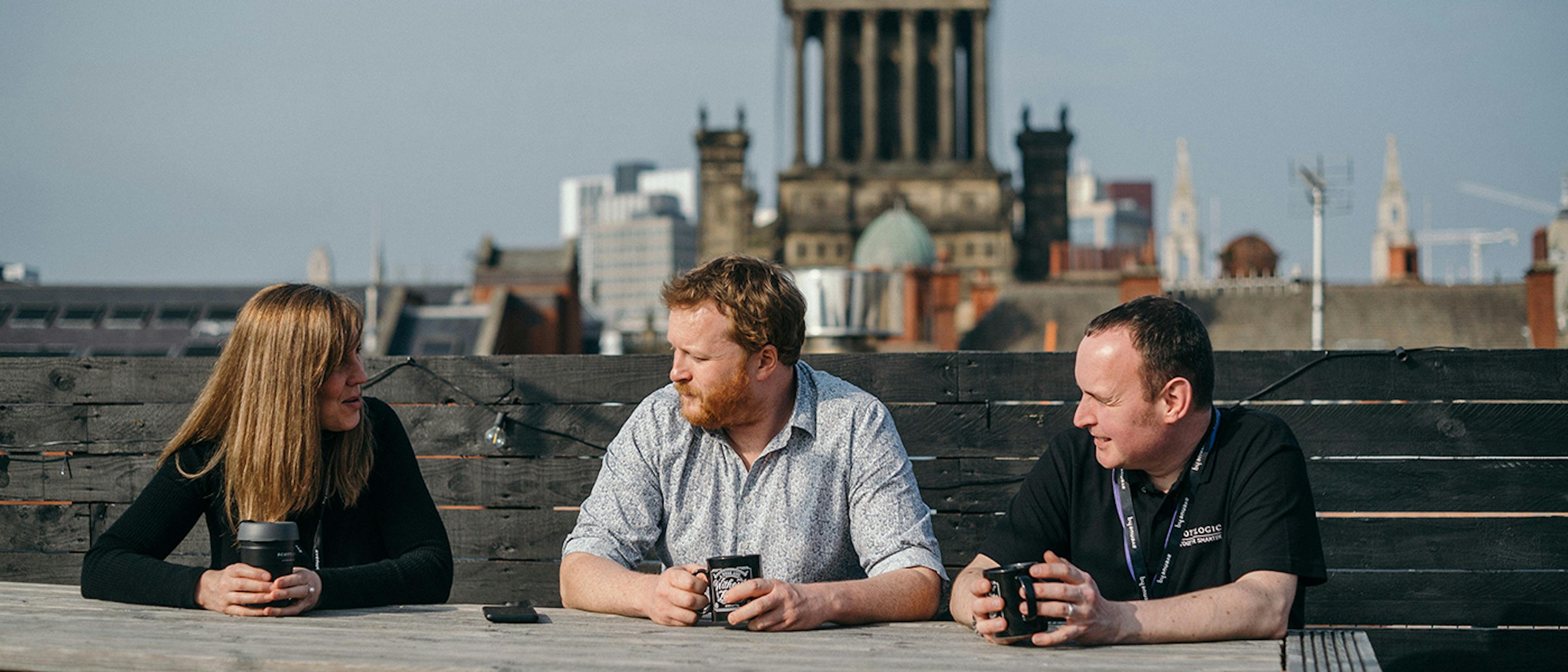 Leeds team members chatting on the office rooftop