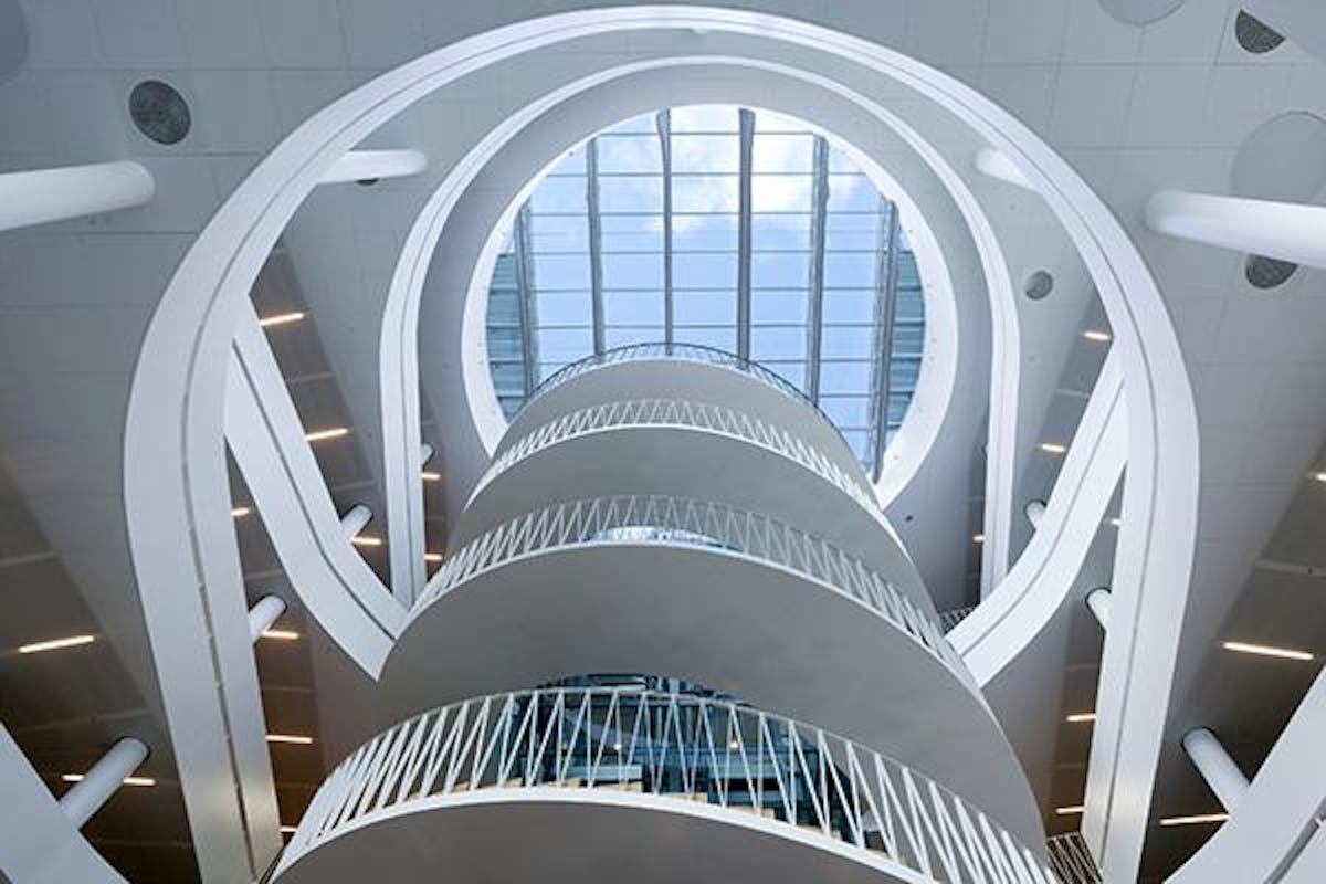 Looking upwards in an atrium with a spiral staircase