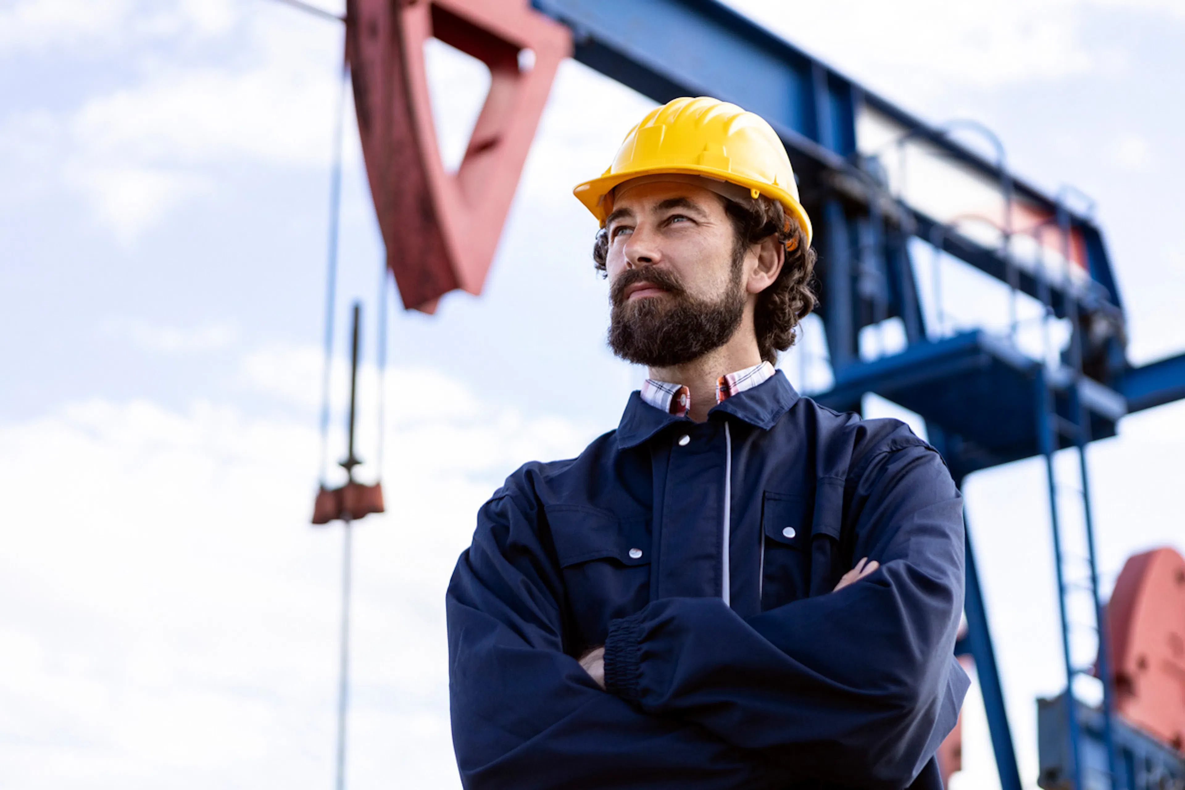 oil and gas worker in the field wearing a hardhat