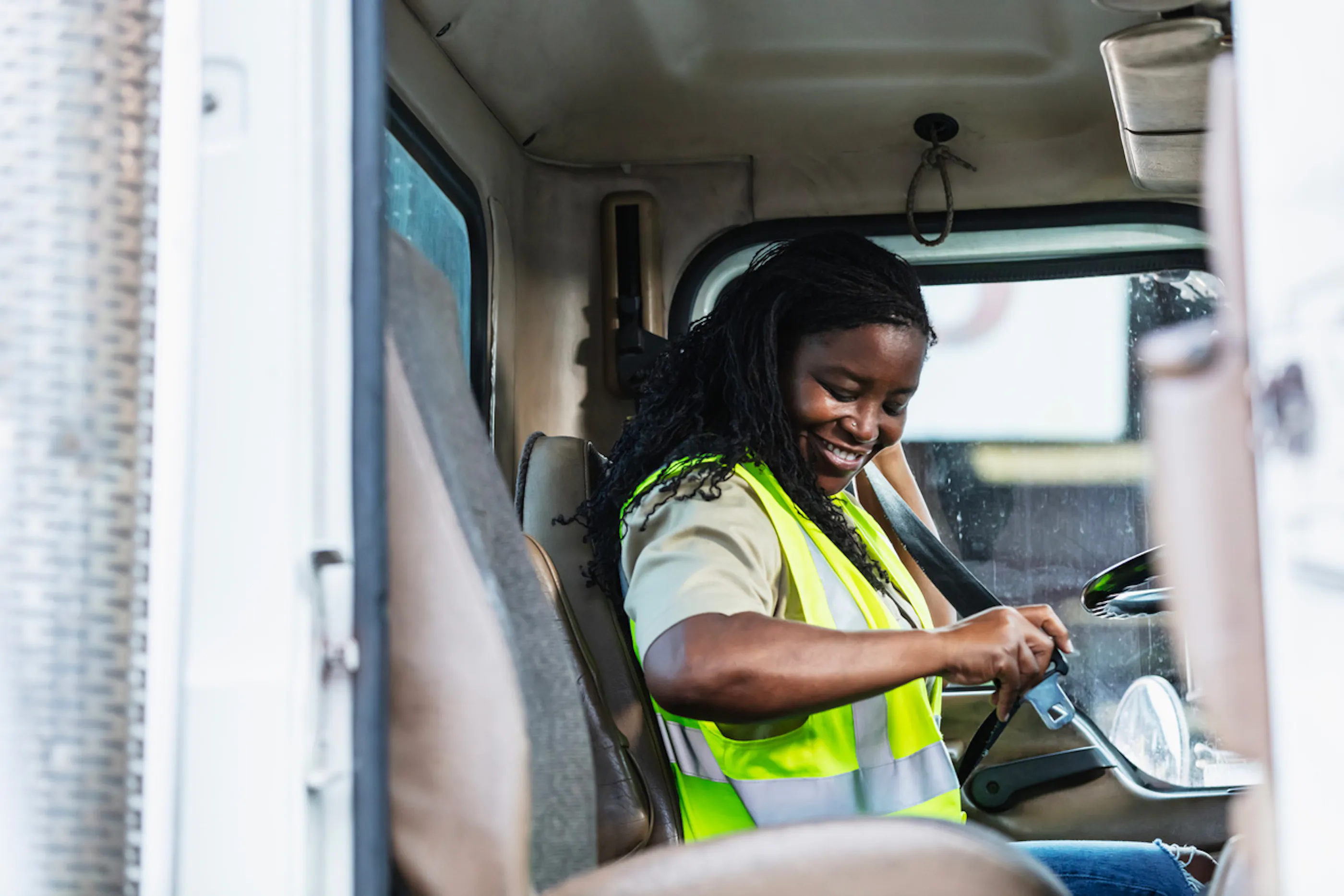 delivery driver putting on a seatbelt