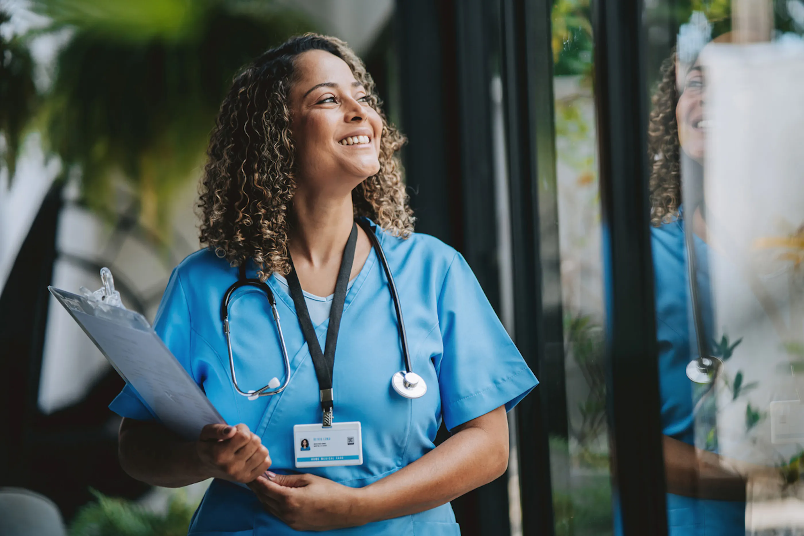 healthcare worker carrying clipboard