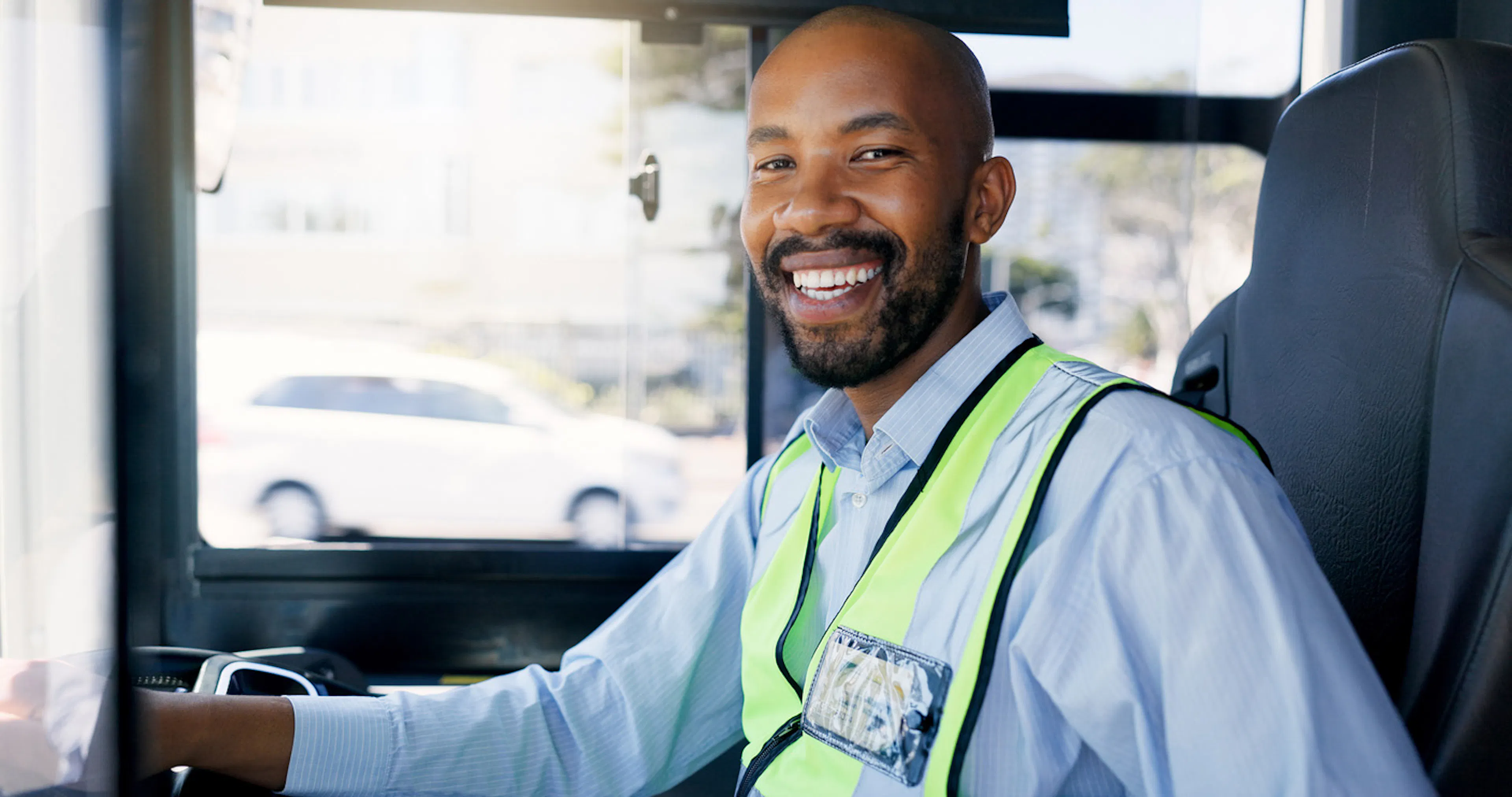 bus driver with yellow safety vest and credentials on lapel