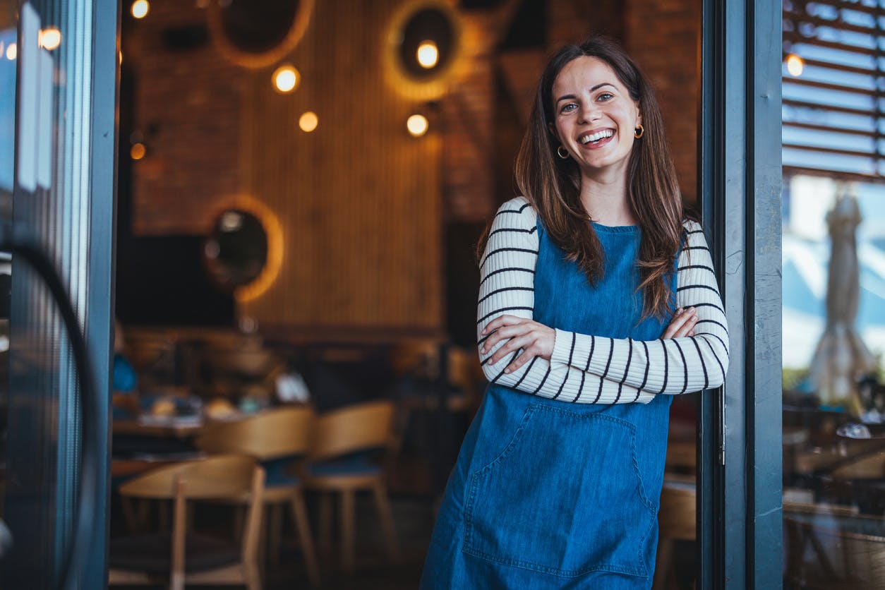 restaurant owner leaning in doorway