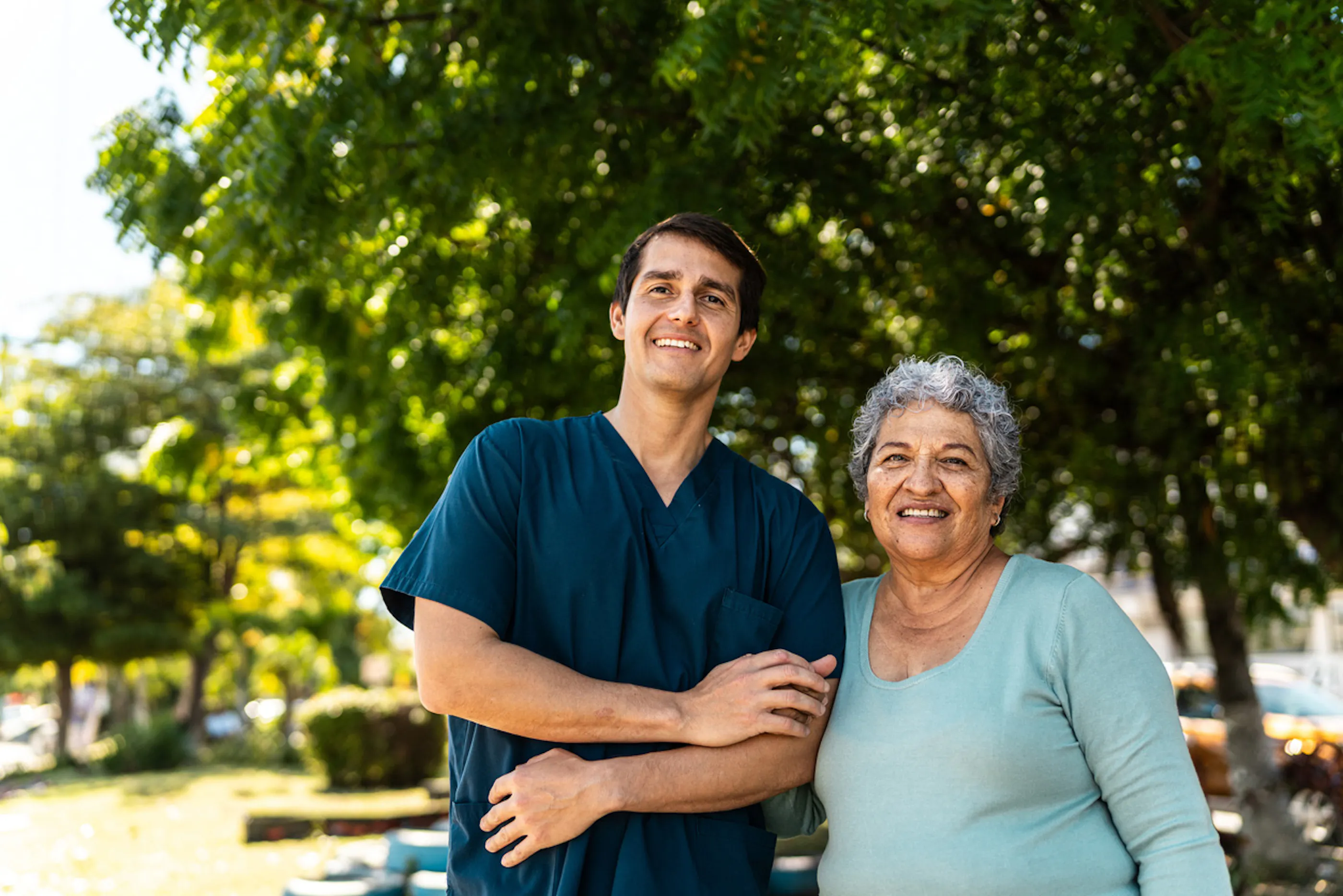 home healthcare worker arm-in-arm with client
