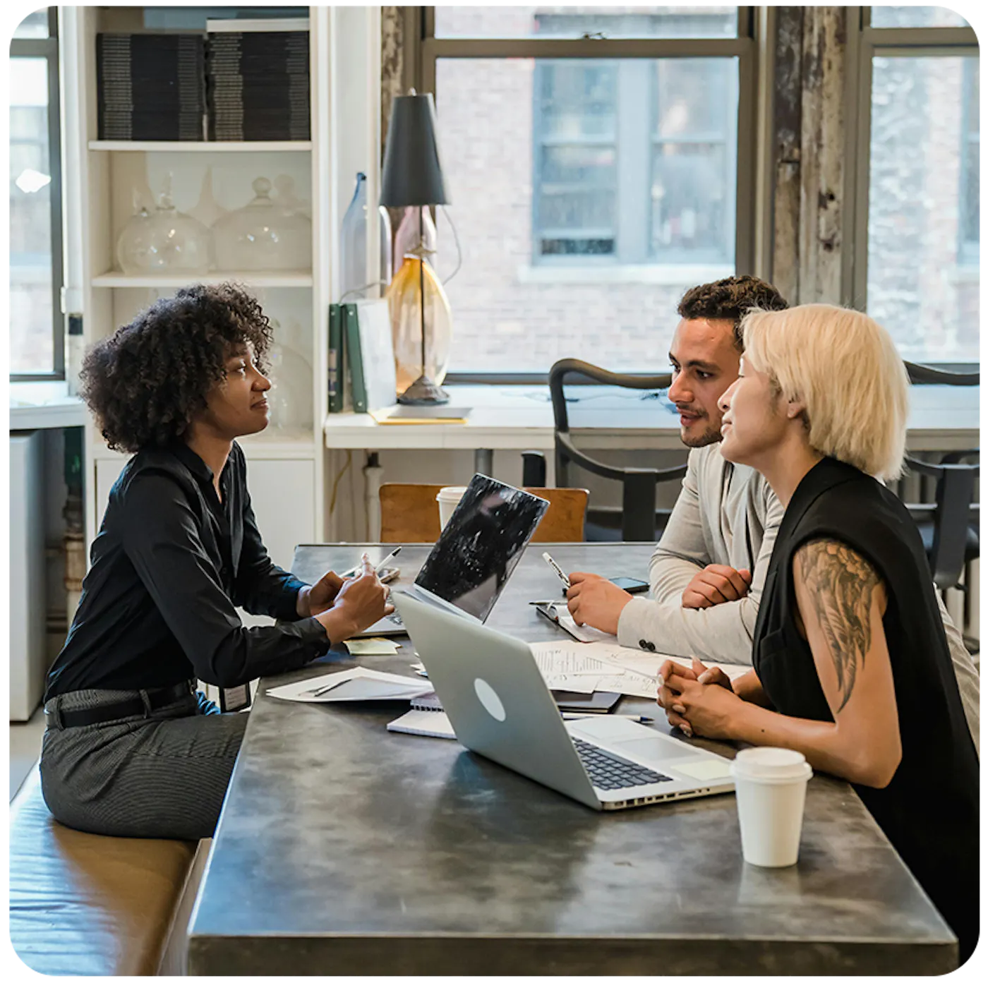 three people working at a desk together