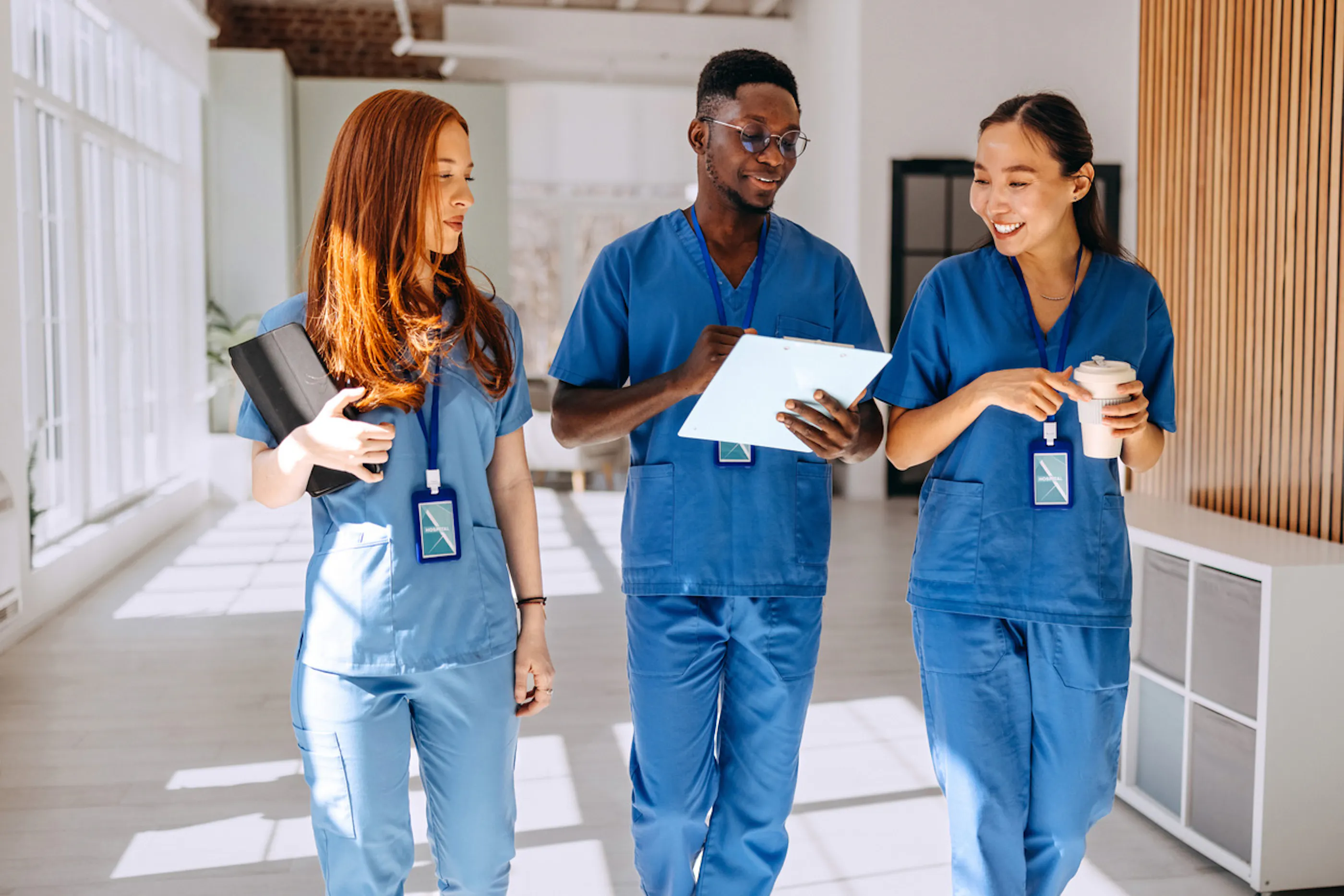 3 healthcare workers consulting a patient chart