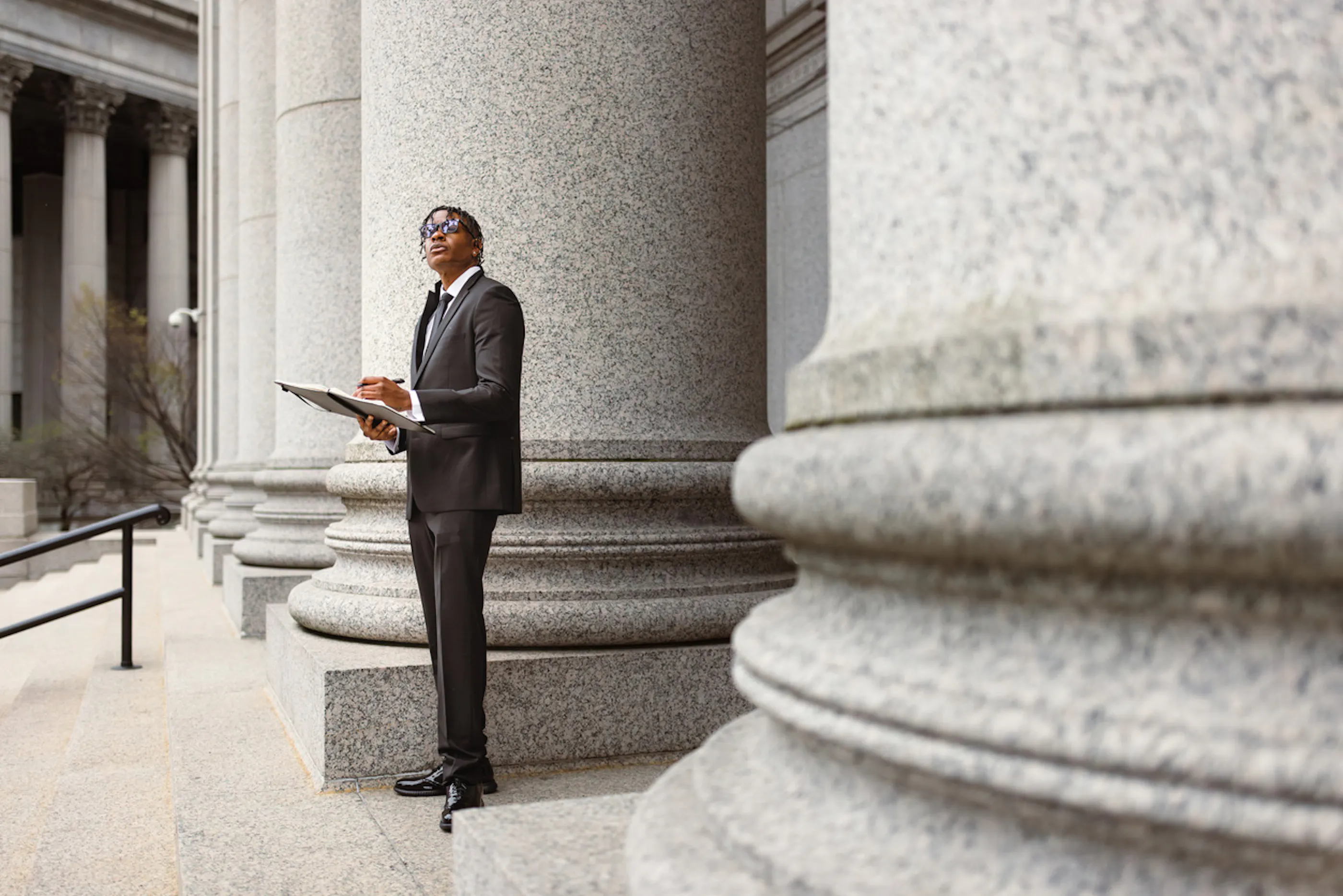 federal worker standing outside consulting a document