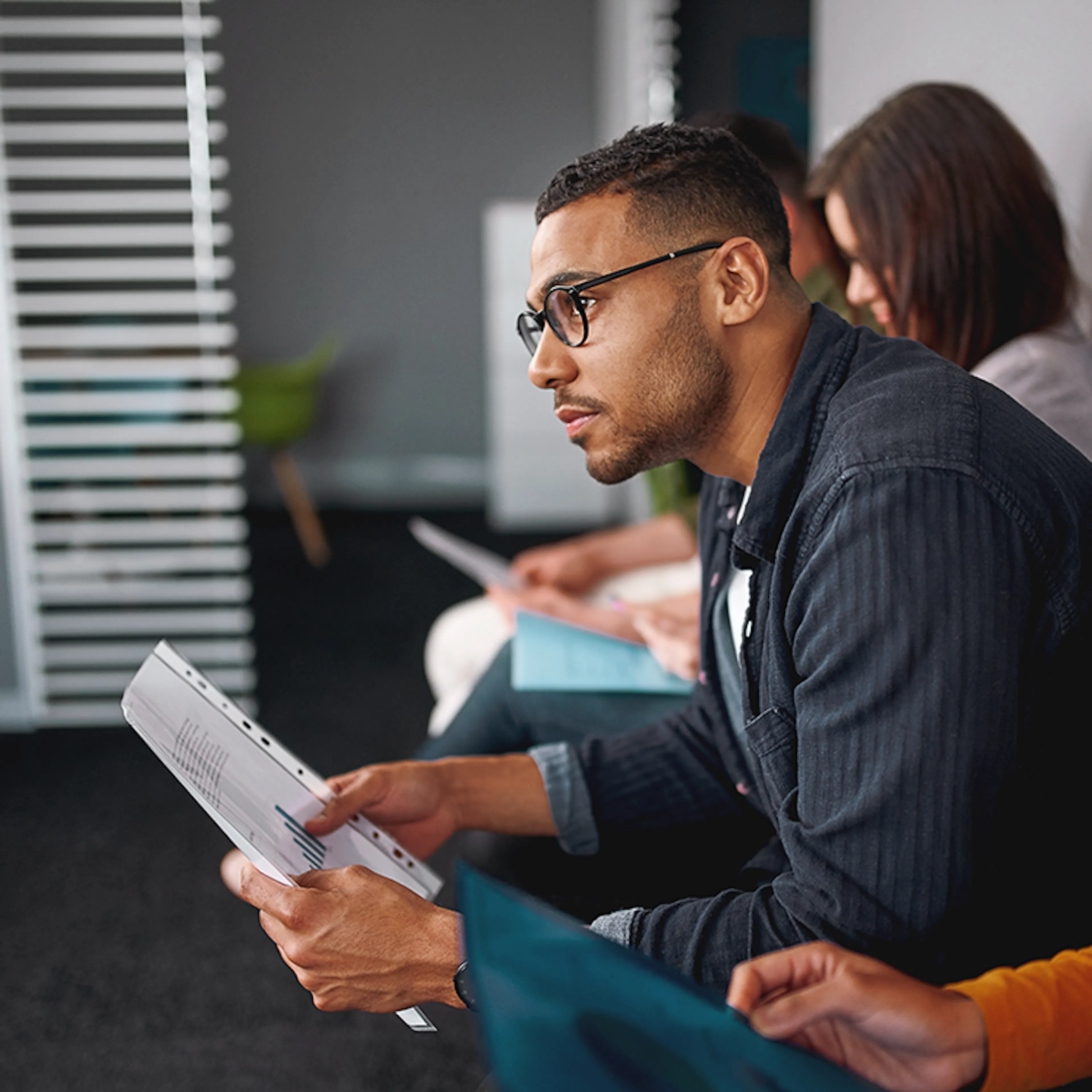 man waiting for interview holding resume