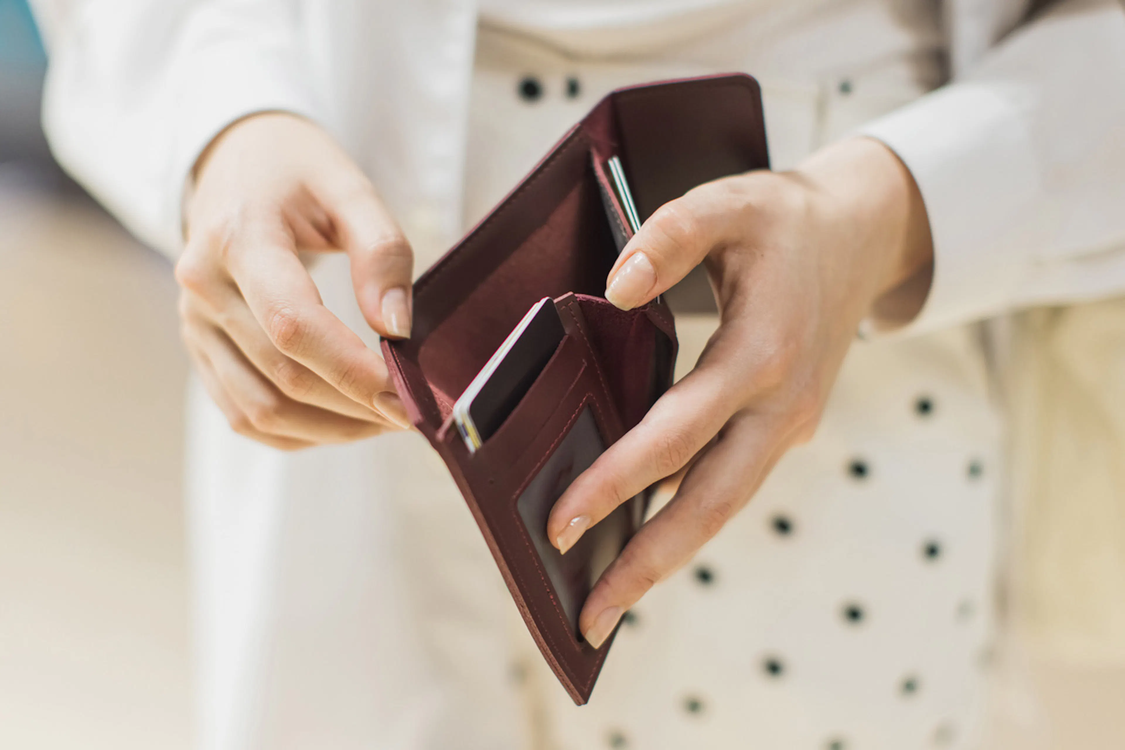 person holding open an empty wallet