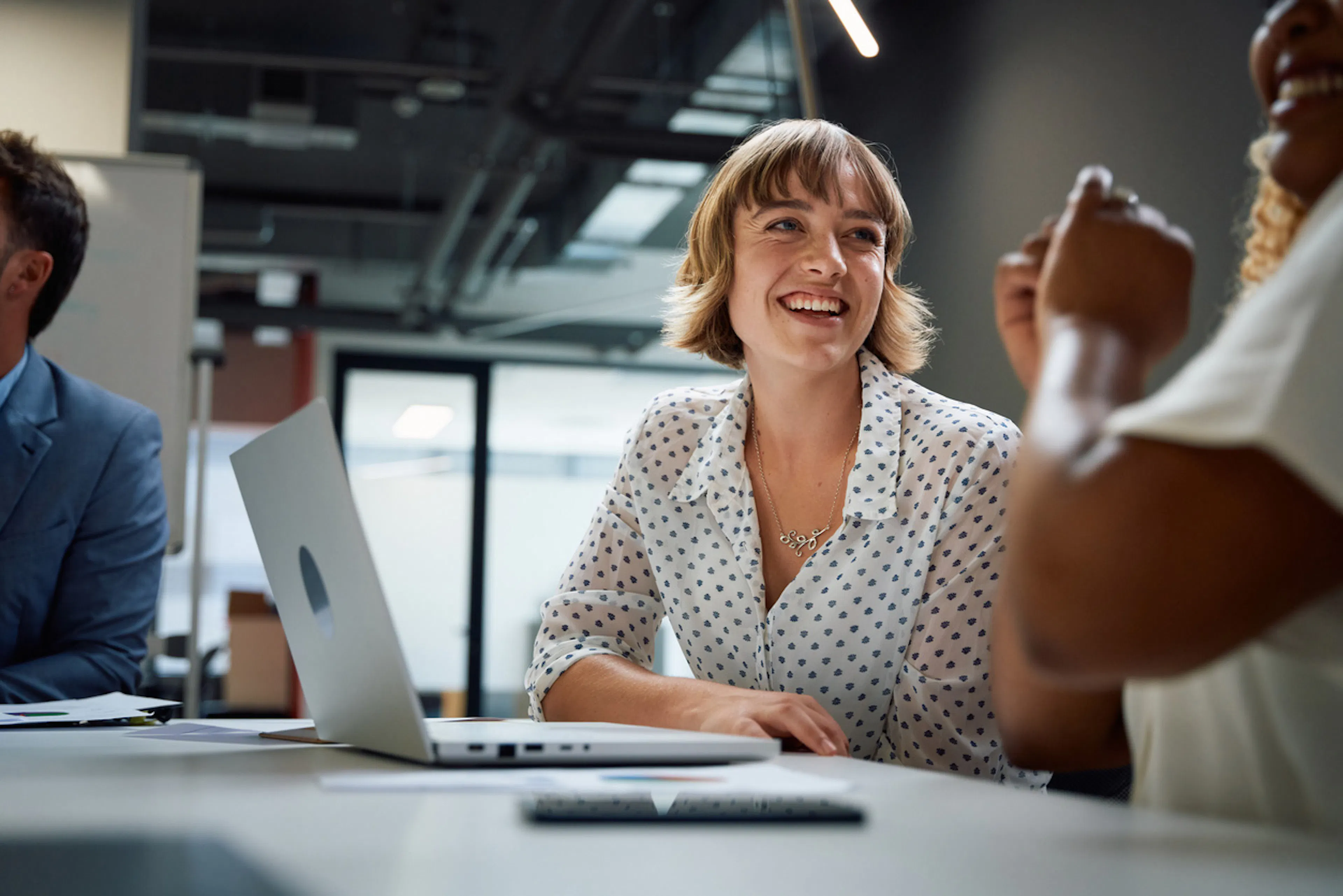 woman at work with two colleagues having a conversation