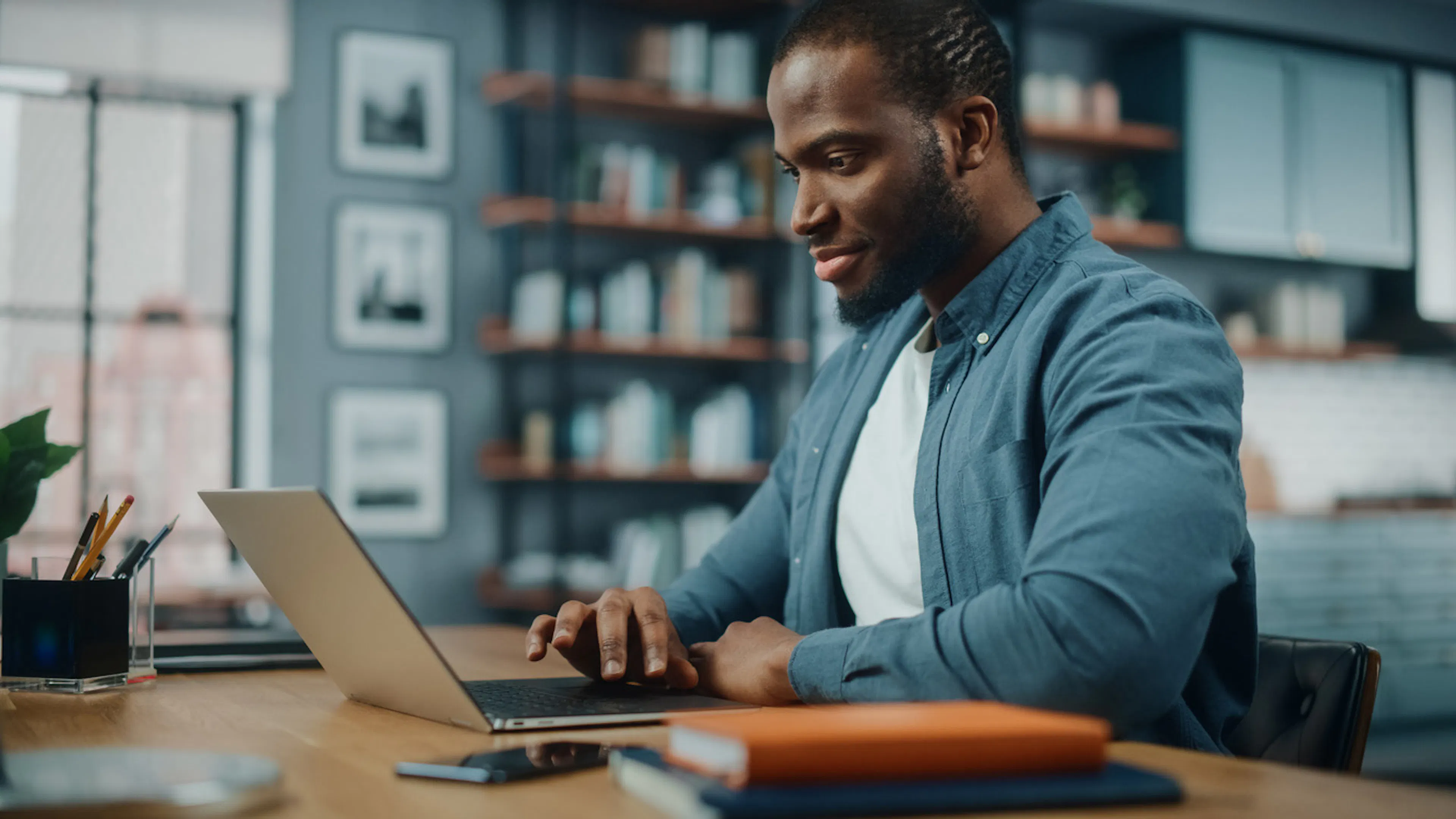 man working on laptop in home office