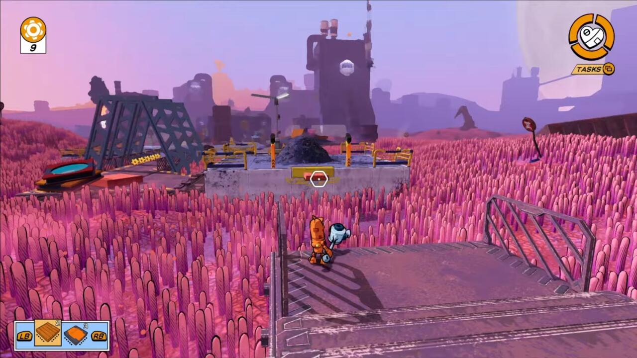 A point-and-click game with a small orange robot standing on a platform over a field of pink cylinders