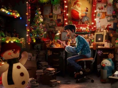 Animation of a young white man in Christmas jumper surrounded by festive decorations and twinkling lights in a cramped and messy office