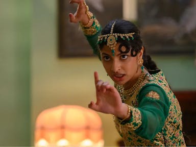Young woman in traditional Pakistani clothing assumes a martial arts position