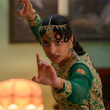 Young woman in traditional Pakistani clothing assumes a martial arts position