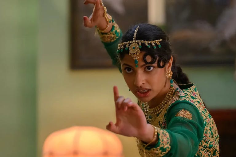 Young woman in traditional Pakistani clothing assumes a martial arts position