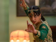 Young woman in traditional Pakistani clothing assumes a martial arts position