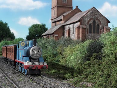 Stop motion animation of a blue train on the tracks riding through greenery past a quaint stone building