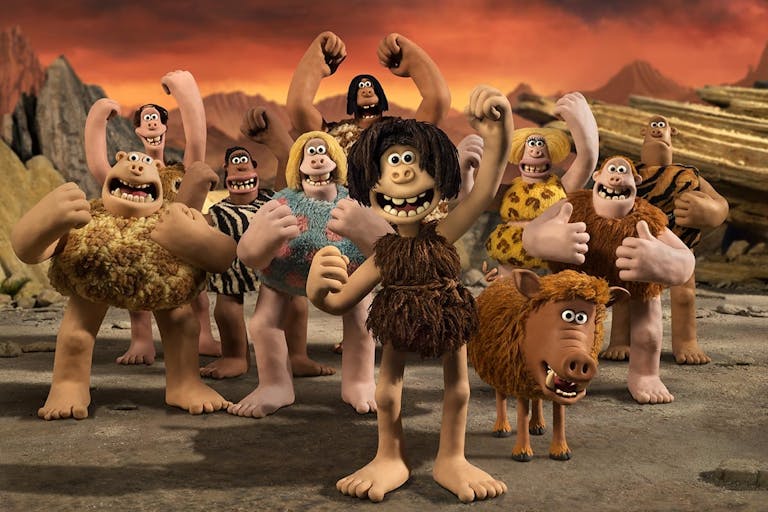 Claymation of a group of characters wearing animal furs in a pre-historic setting
