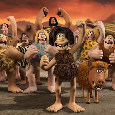 Claymation of a group of characters wearing animal furs in a pre-historic setting