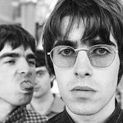 Black and white photo of young men, one in sunglasses, one sticking out his tongue.