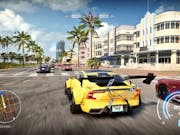 Video game image of a bright yellow sports car racing through a city street lined with palm trees.