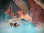 Gameplay of a beautiful mystic space setting, of a basic flying vehicle amongst wispy clouds and large galactic rock mountains