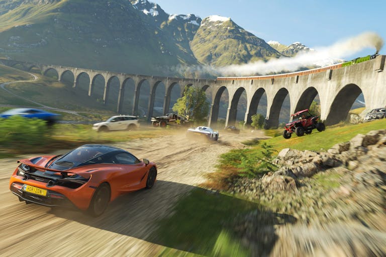 Gameplay of a car speeding towards a viaduct in a scenic, mountain landscape