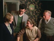 Two women and two men in 50s clothing in a homely working class house