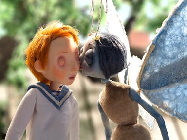 Animated image of a blue spider in a woman's form kissing the cheek of a boy with ginger hair