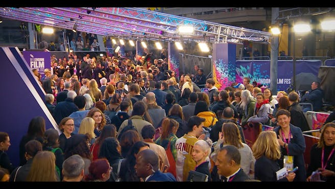Large crowd of people at a red carpet event.