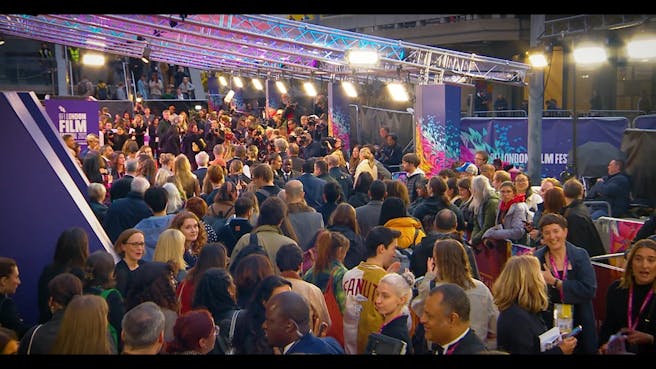 Large crowd of people at a red carpet event.