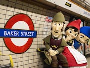 Animated scene of Sherlock Gnomes with two other gnomes, standing in the London Underground next to a sign for Baker Street.
