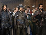 Three men wearing steampunk, leather combat wear in a period setting