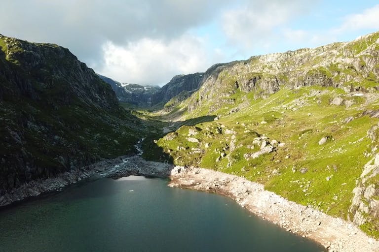 Beautiful sunny shot of a tarn and hills in the Lake District