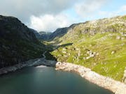 Beautiful sunny shot of a tarn and hills in the Lake District