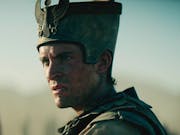 A white man with a sweaty dirty face in armour and a grand Egyptian helmet